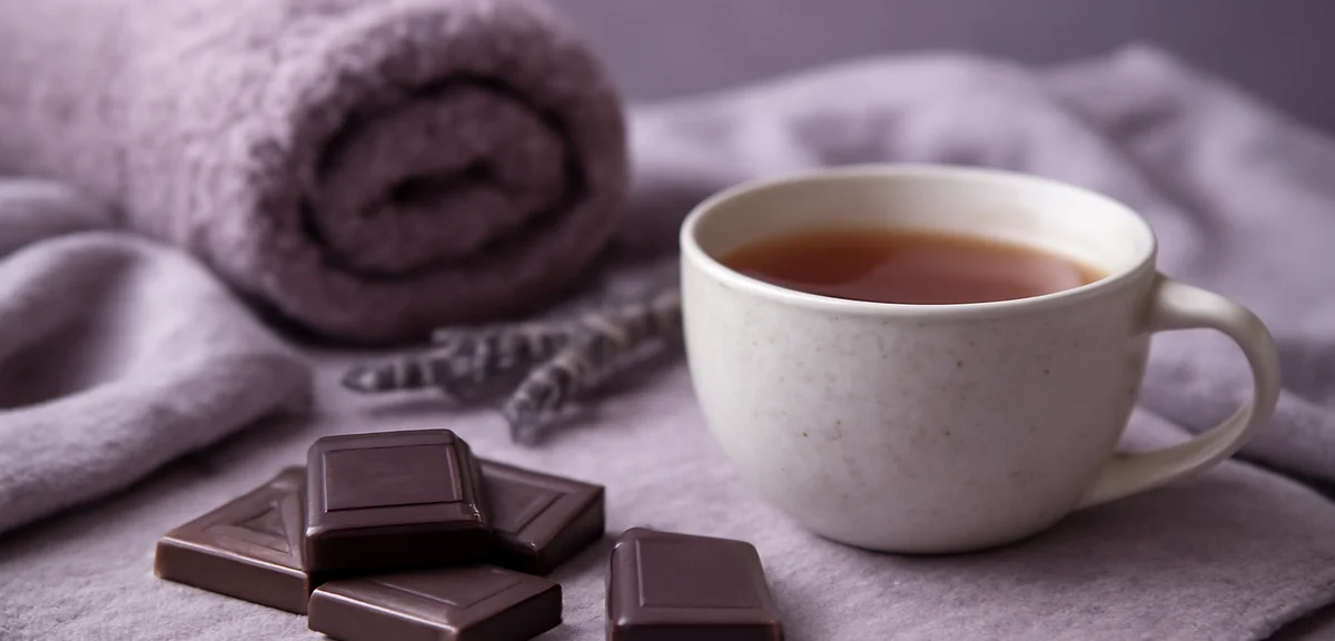 Calming purple-toned functional chocolate pieces arranged with relaxation theme elements like a cup 